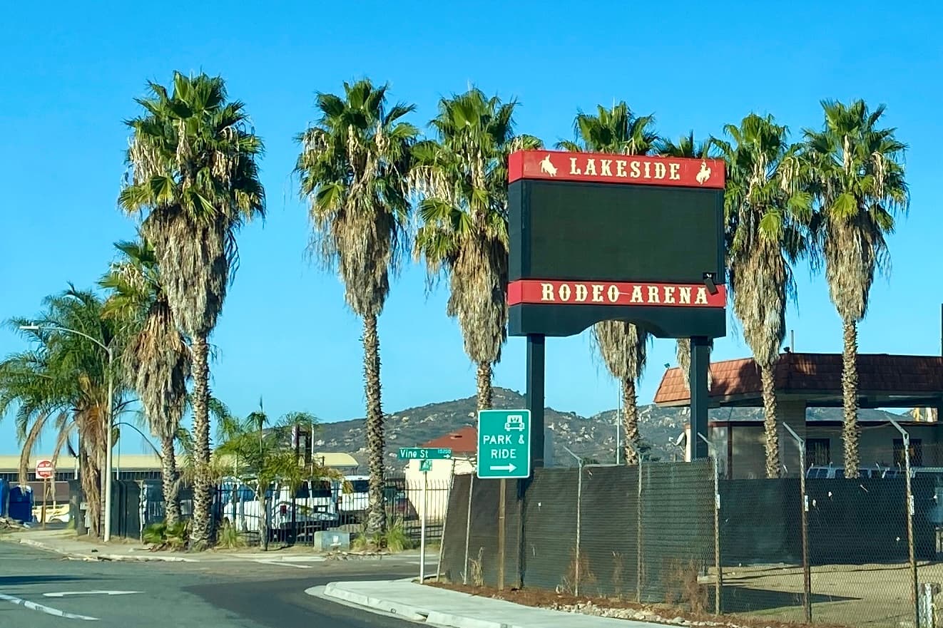 Lakeside Rodeo Arena sign with palm trees and East County hills